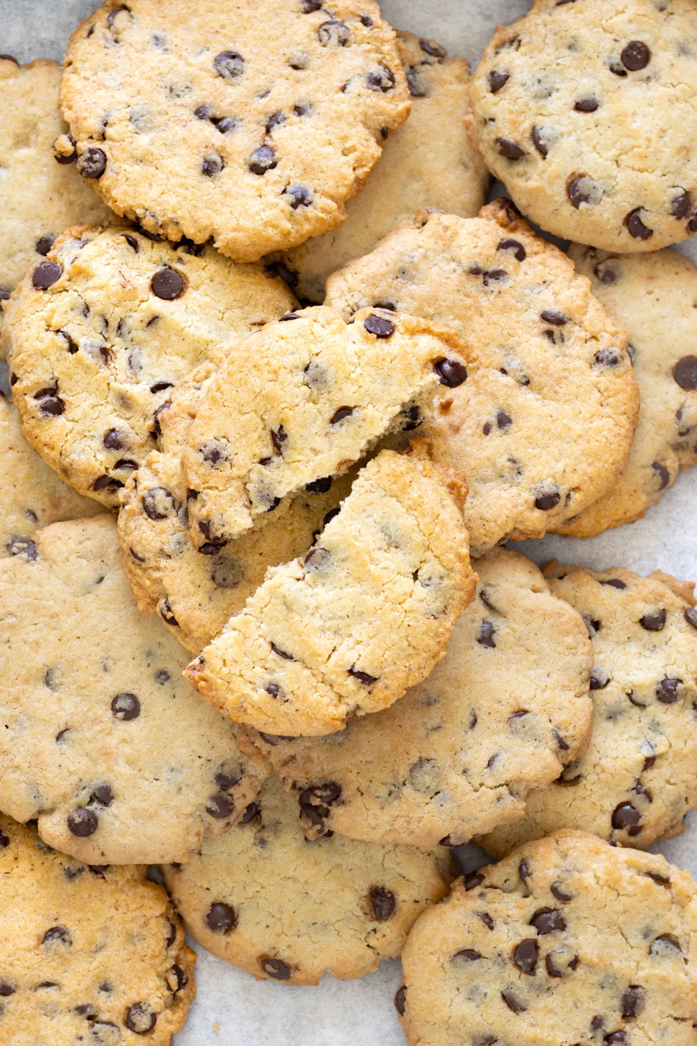 Baked brown butter chocolate chip cookies with one broken open